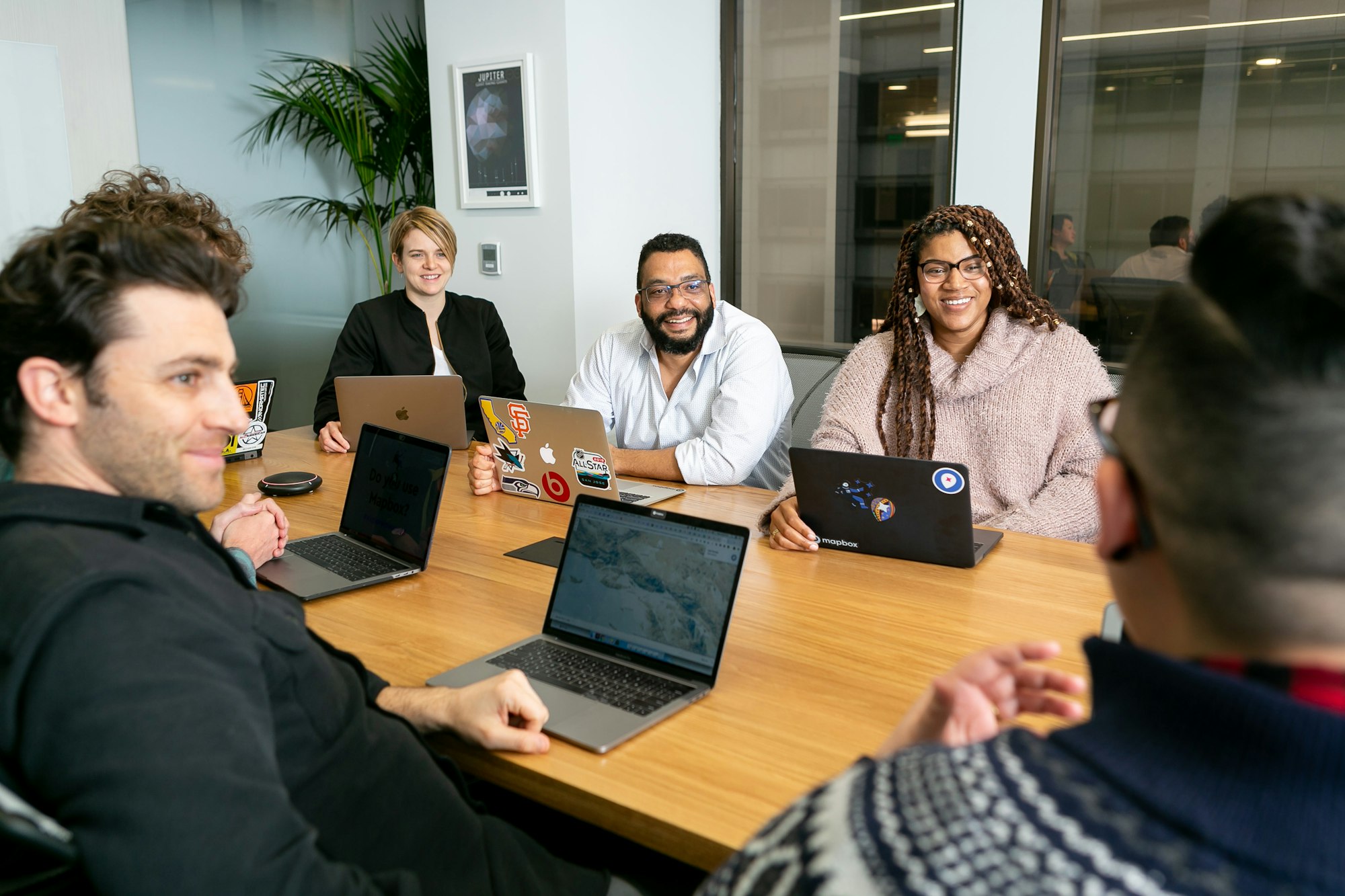 A finance team reviewing payments together on laptops
